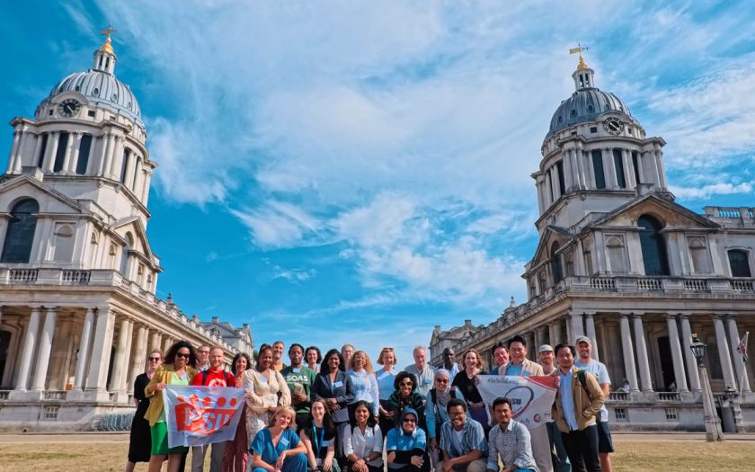 Participants of the PSIRU Summer School 2026 pose for a group photo in front of the Old Royal Naval College buildings at the University of Greenwich campus